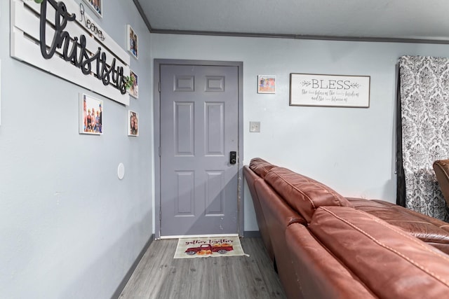 interior space with hardwood / wood-style flooring and crown molding