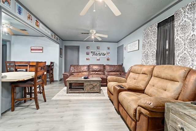 living room featuring light hardwood / wood-style floors and ceiling fan