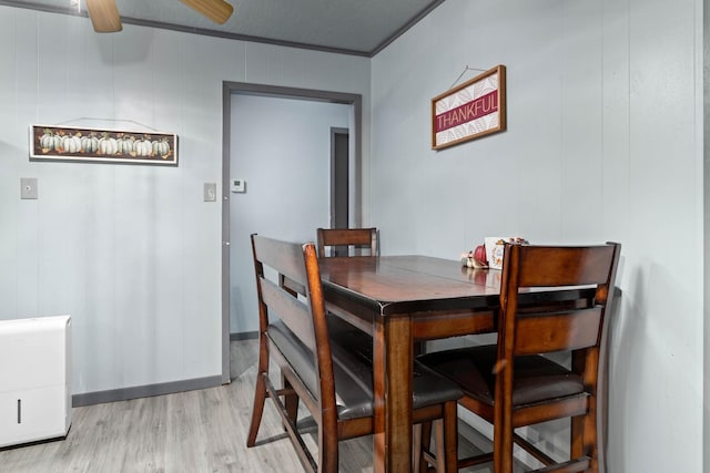 dining space featuring light hardwood / wood-style flooring, ceiling fan, and ornamental molding