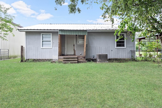 view of front of house with a front yard and cooling unit