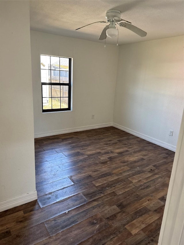 unfurnished room featuring ceiling fan, dark wood-type flooring, and a textured ceiling