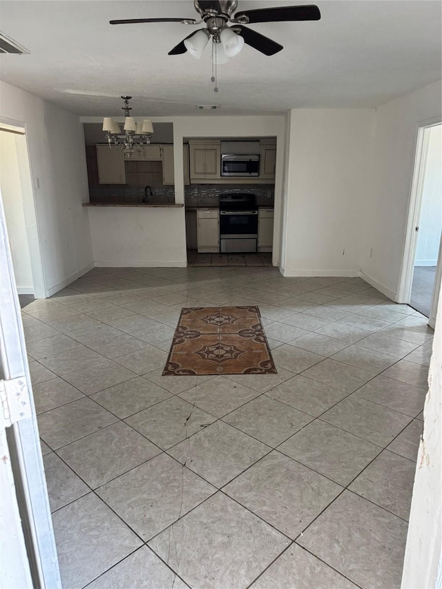 unfurnished living room with ceiling fan with notable chandelier, sink, and light tile patterned flooring