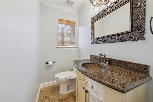 bathroom with ornamental molding, vanity, and toilet