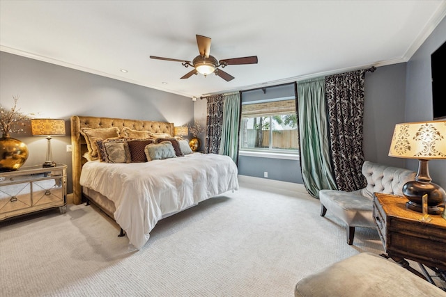 carpeted bedroom featuring ceiling fan and crown molding