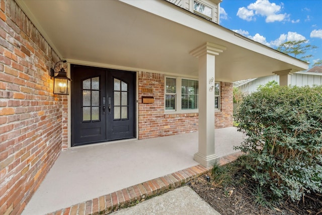 view of exterior entry featuring french doors