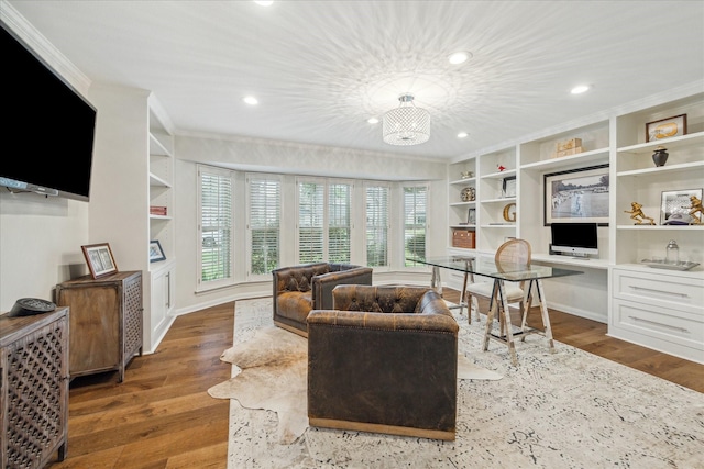 living room with wood-type flooring, built in desk, and built in features