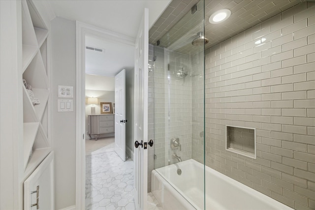 bathroom featuring tile patterned flooring and tiled shower / bath combo