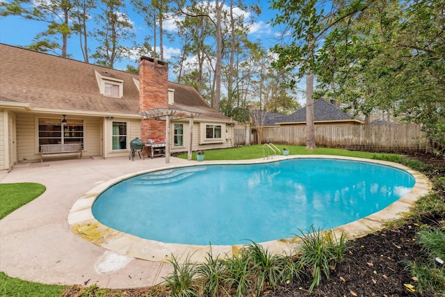 view of pool with a patio, grilling area, and a pergola