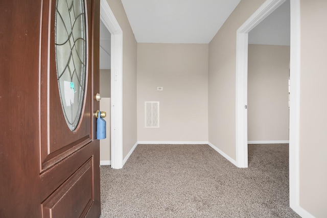 foyer entrance with light colored carpet