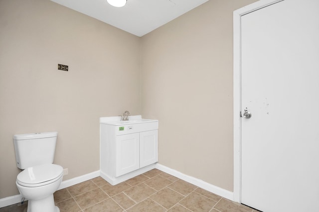 bathroom featuring tile patterned floors, vanity, and toilet