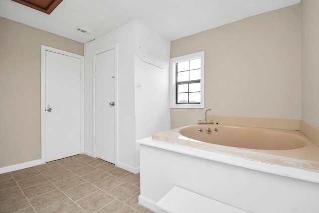 bathroom with tile patterned floors and a bathing tub