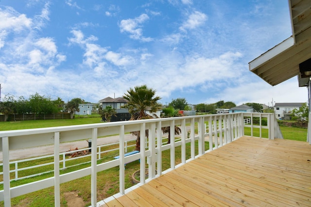 wooden deck with a lawn