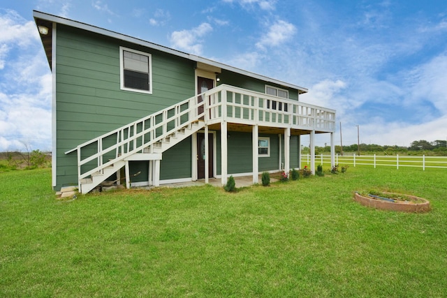 back of house with a lawn and a deck