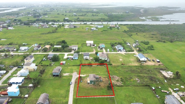 drone / aerial view featuring a water view and a rural view