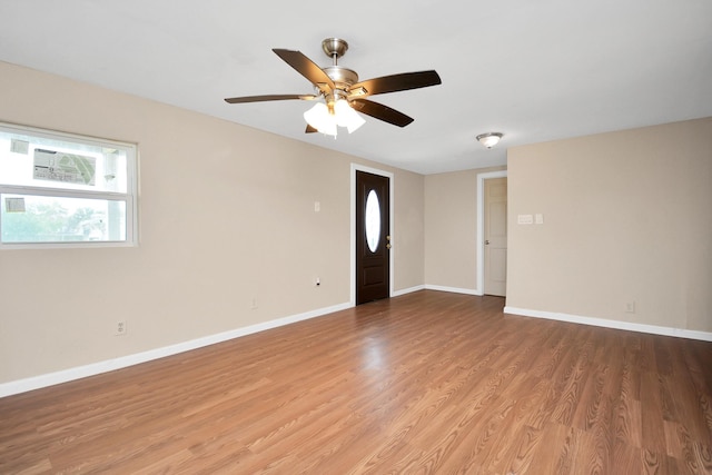 spare room with hardwood / wood-style flooring and ceiling fan