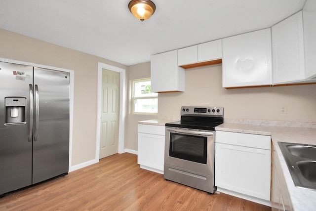 kitchen with light hardwood / wood-style flooring, sink, stainless steel appliances, and white cabinetry