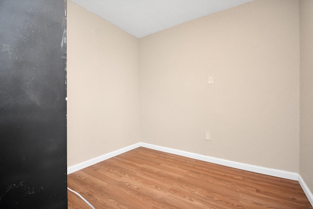 empty room with hardwood / wood-style floors