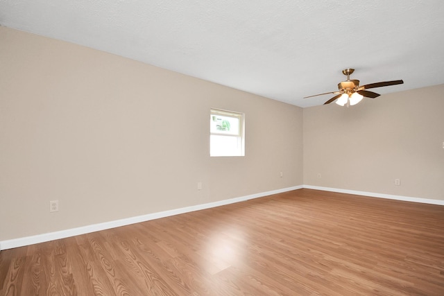 unfurnished room with a textured ceiling, ceiling fan, and light hardwood / wood-style floors