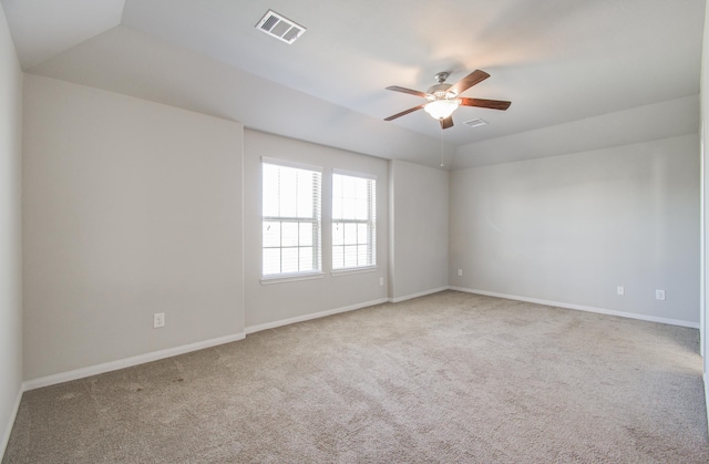 unfurnished room with vaulted ceiling, ceiling fan, and carpet flooring