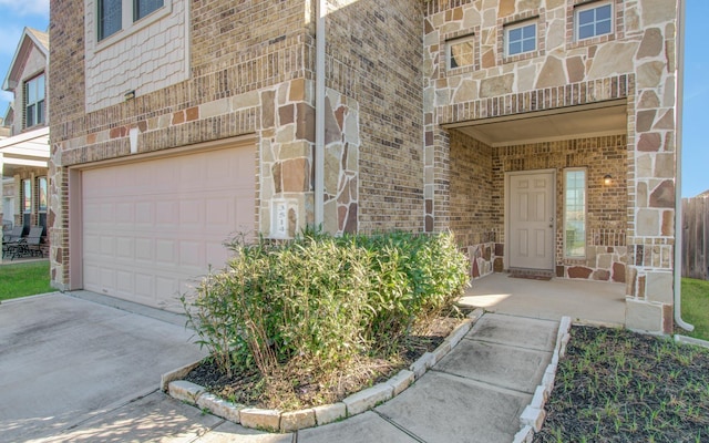 doorway to property with a garage