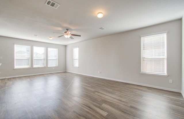 empty room with ceiling fan and wood-type flooring