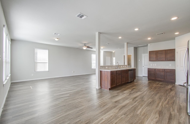 kitchen featuring hardwood / wood-style flooring, plenty of natural light, stainless steel dishwasher, and ceiling fan