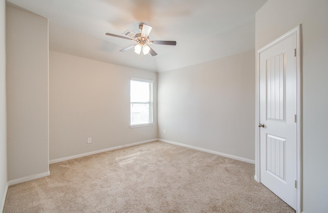 unfurnished room with ceiling fan and light colored carpet