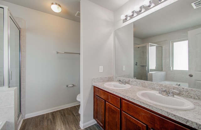 full bathroom with separate shower and tub, vanity, toilet, and hardwood / wood-style flooring