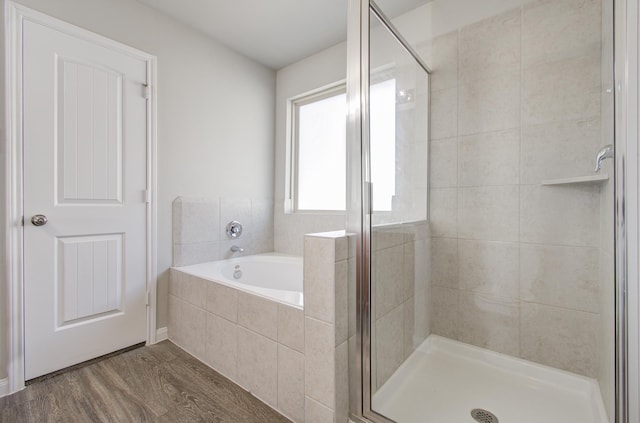 bathroom with plus walk in shower and hardwood / wood-style floors