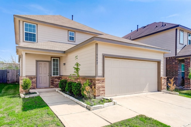 view of front of house with a front lawn and a garage