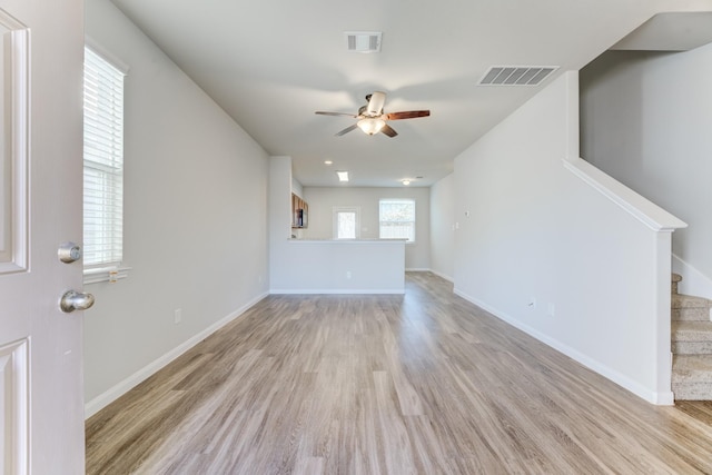 unfurnished living room with light wood-type flooring and ceiling fan