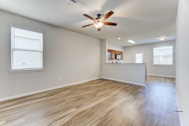 spare room with light hardwood / wood-style flooring and ceiling fan