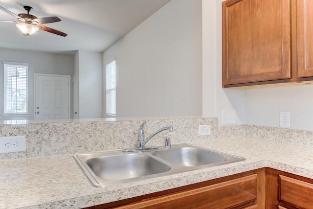 kitchen featuring ceiling fan, a wealth of natural light, and sink