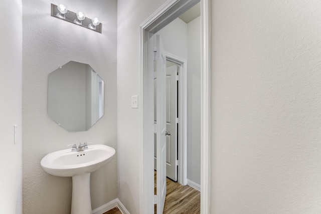 bathroom with sink and hardwood / wood-style flooring