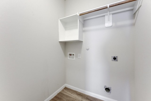 clothes washing area featuring washer hookup, gas dryer hookup, wood-type flooring, and electric dryer hookup