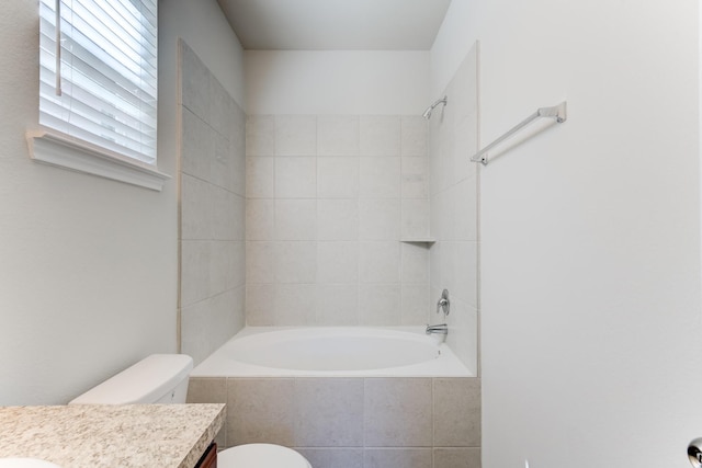 full bathroom with tiled shower / bath combo, toilet, and vanity