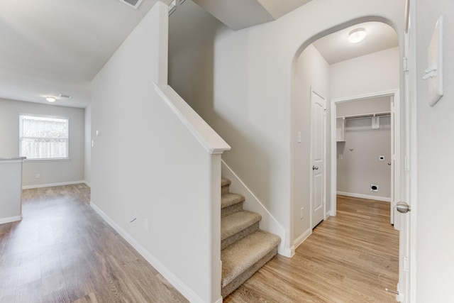 stairway with hardwood / wood-style floors