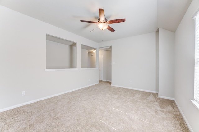 carpeted empty room featuring ceiling fan