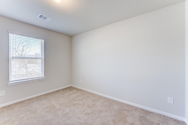 unfurnished room with light carpet