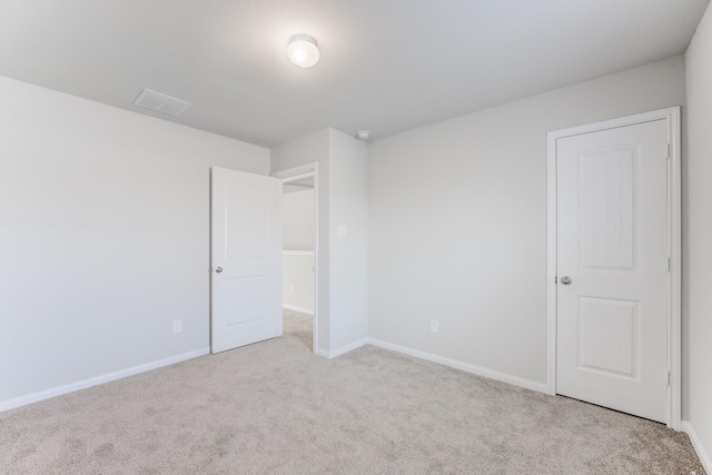 unfurnished bedroom with light colored carpet