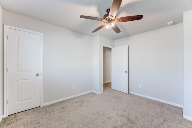 unfurnished bedroom featuring light carpet and ceiling fan