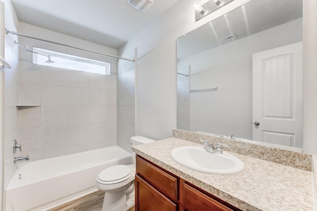 full bathroom with toilet, vanity, tiled shower / bath combo, and wood-type flooring