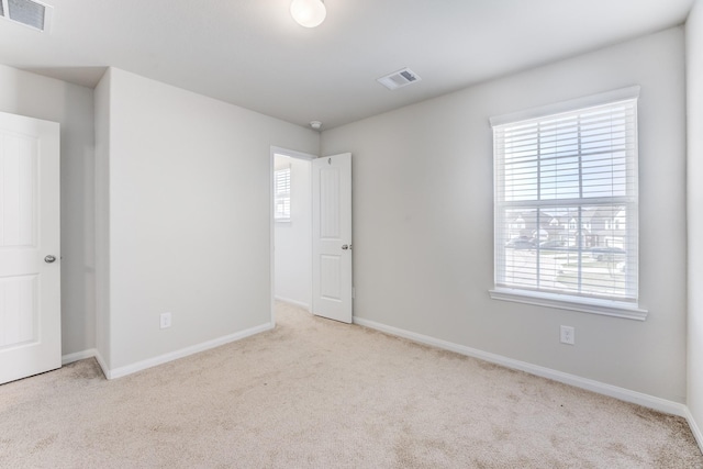 spare room with light colored carpet