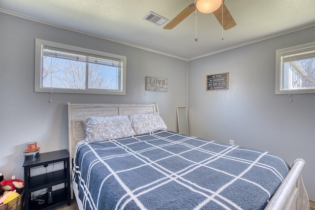 bedroom featuring ceiling fan and ornamental molding