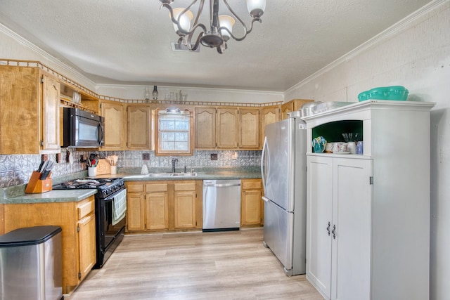 kitchen with light hardwood / wood-style flooring, pendant lighting, black appliances, ornamental molding, and tasteful backsplash