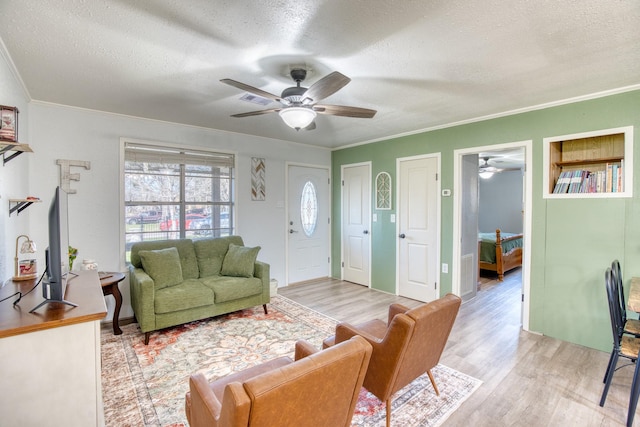 living room with light hardwood / wood-style flooring and a textured ceiling