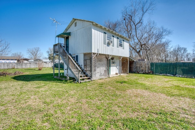 rear view of house featuring a yard