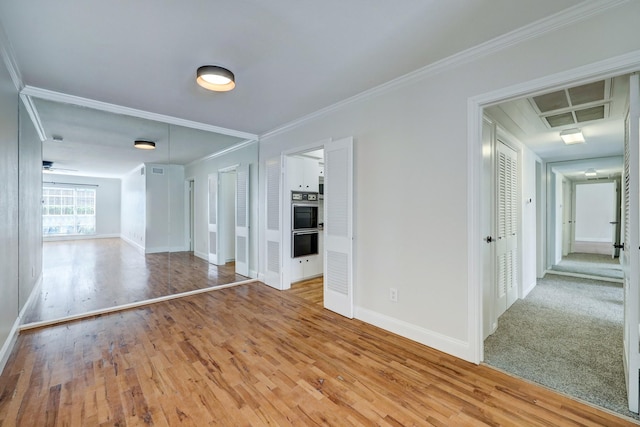 spare room featuring ornamental molding and hardwood / wood-style floors