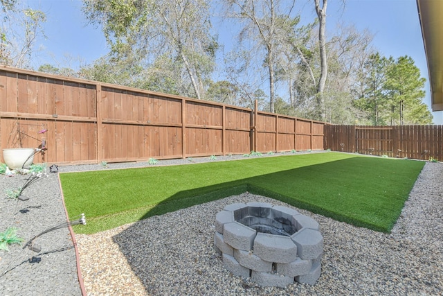 view of yard featuring a fenced backyard and an outdoor fire pit