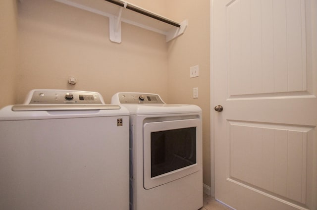 laundry area with washing machine and clothes dryer